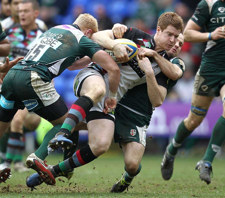 Quins' Rory Clegg is tackled by the London Irish defence