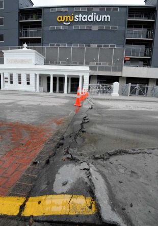 Water pours from a broken water main outside the AMI Stadium, Christchurch, New Zealand, February 26, 2011
