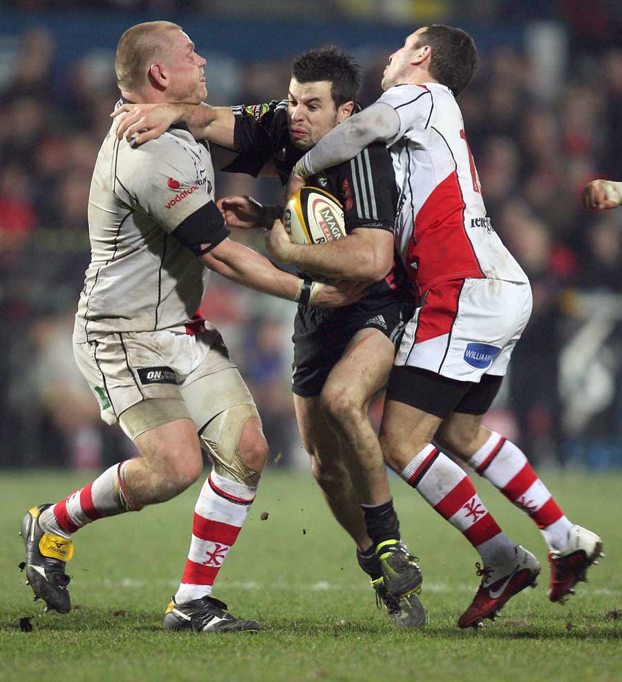 Aironi's James Marshall is tackled by Ulster's Tom Court and Paddy Wallace