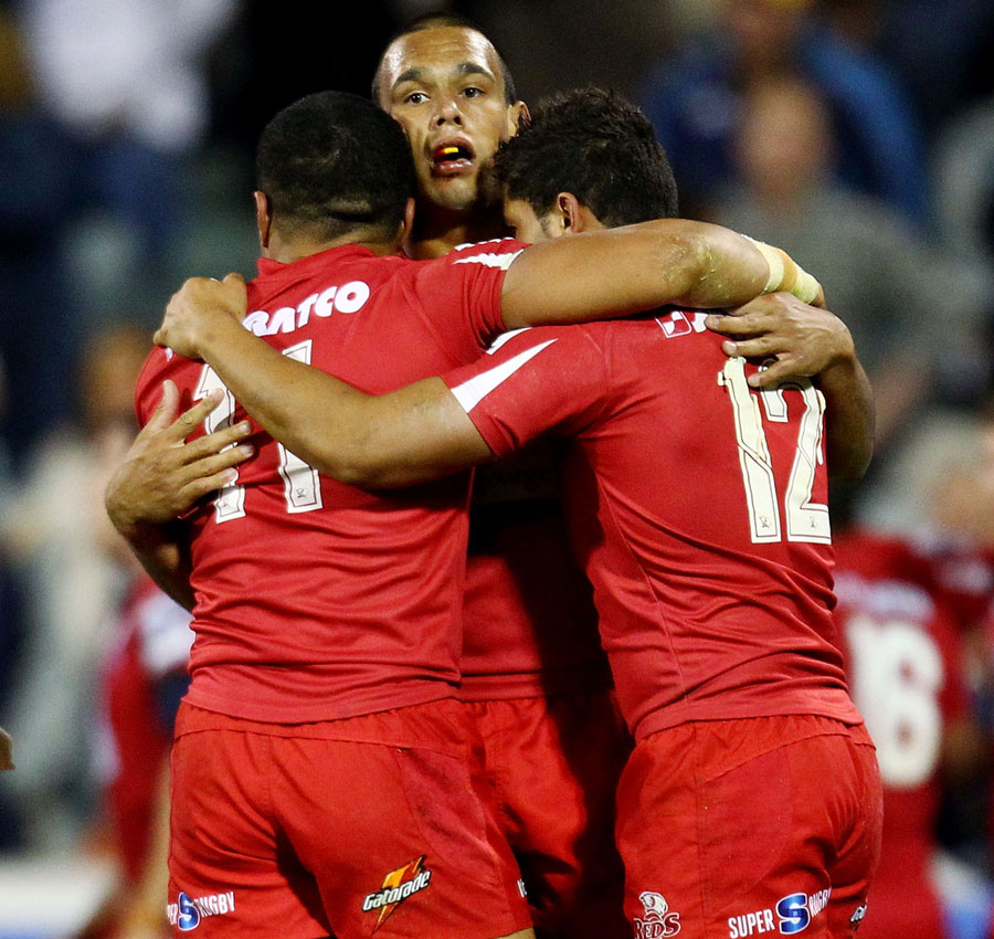 The Reds' Will Chambers, Digby Ioane and Anthony Faingaa celebrate victory