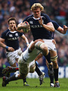 Scotland lock Richie Gray is caught by a tackle from behind