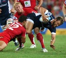 The Rebels' Lachlan Mitchell is shackled by the Reds' defence