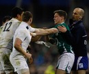 Ireland fly-half Ronan O'Gara faces up to England's Chris Ashton and Shontayne Hape