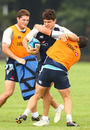 Waratahs centre Tom Carter is wrapped up