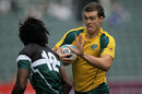 Australia's John Grant fends off a Zimbabwean defender