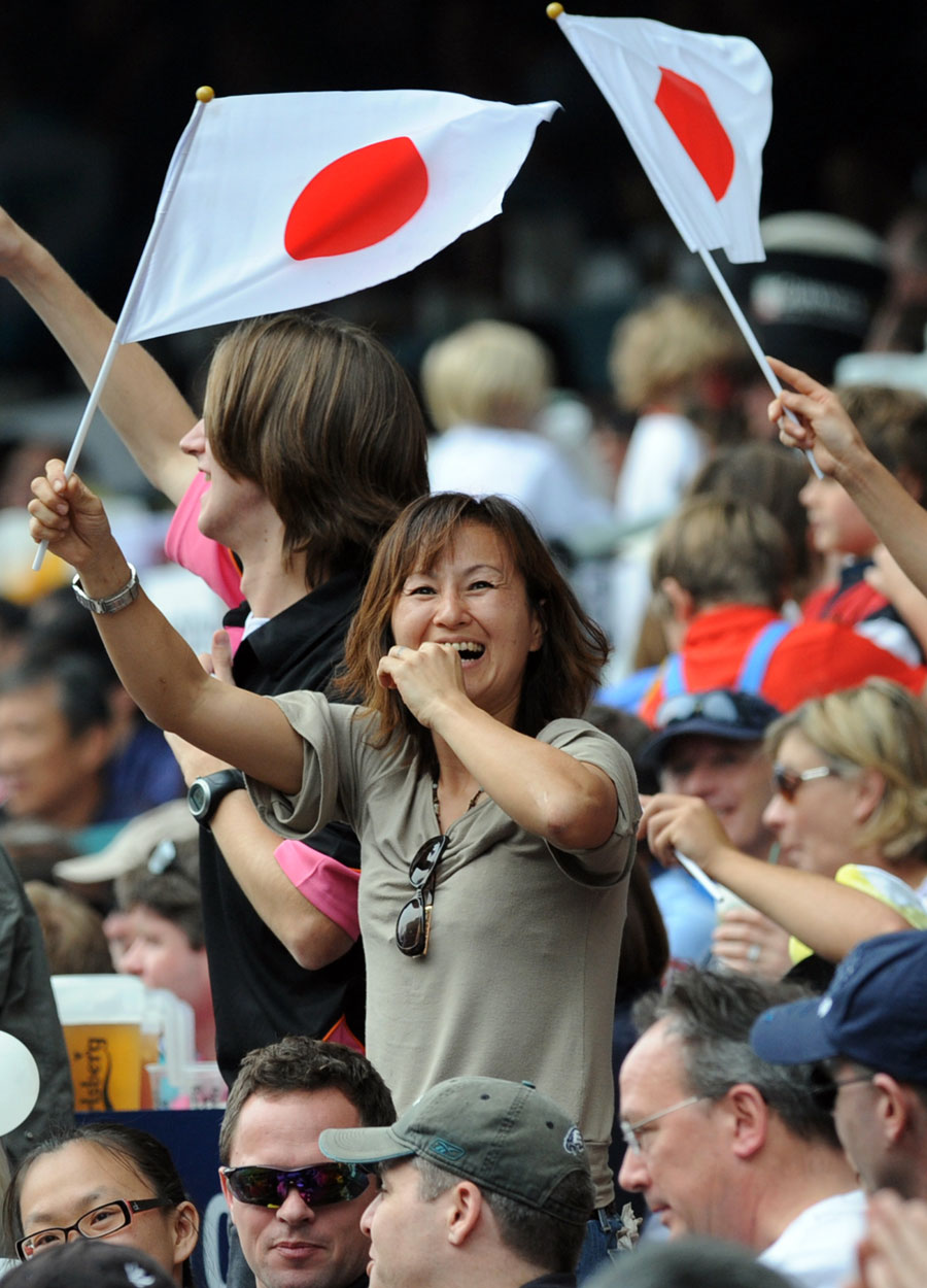 Japanese fans raise the flag at the Hong Kong Stadium
