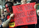 A Crusaders fan holds a placard supporting the earthquake-hit city of Christchurch