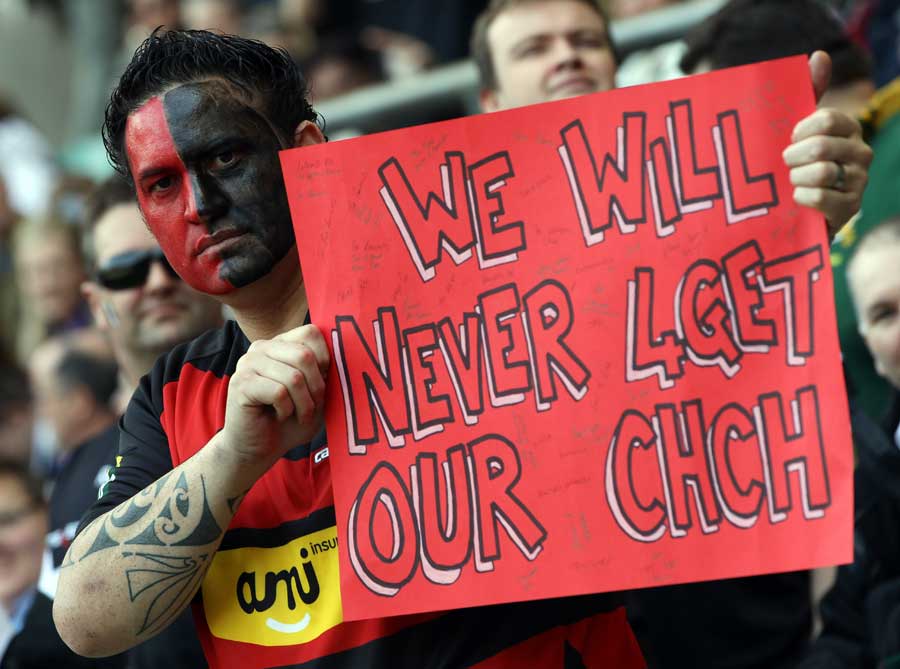 A Crusaders fan holds a placard supporting the earthquake-hit city of Christchurch, Crusaders v Sharks, Super Rugby, Twickenham, England, March 27, 2011