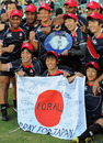 Japan's players hold a 'Pray For Japan' flag after their Shield success