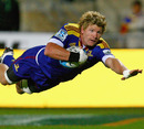The Highlanders' Adam Thomson dives over to score