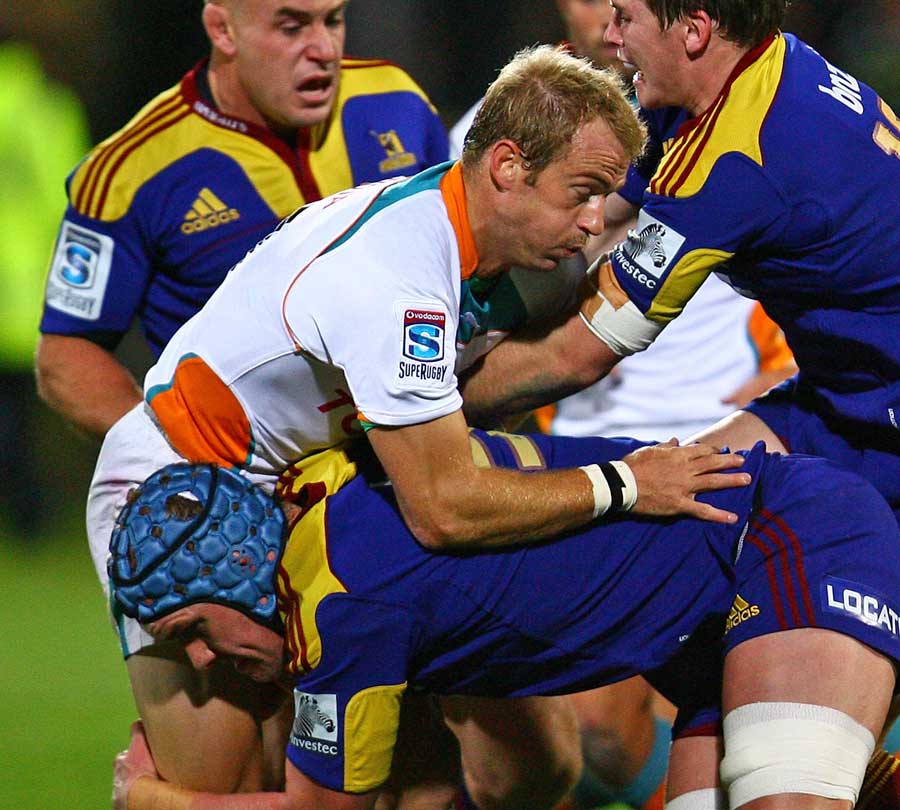 The Cheetahs' Sarel Pretorius is wrapped up by the Highlanders
