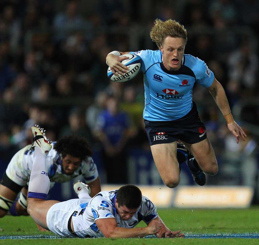 Waratahs centre Ryan Cross is caught by a tap-tackle