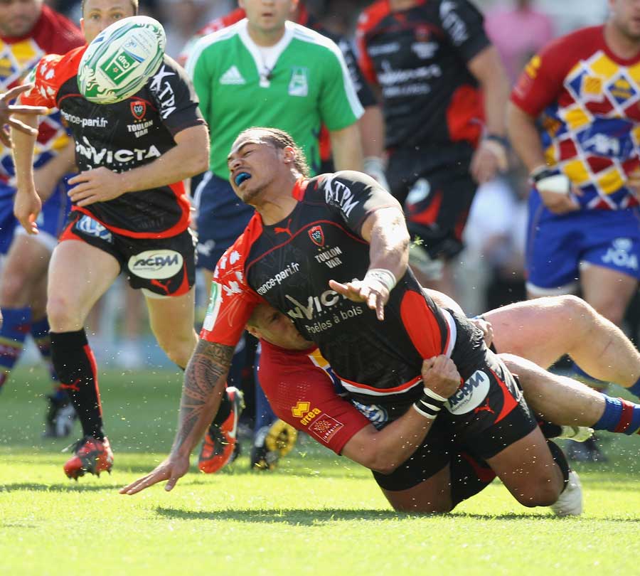 Toulon's Christian Loamanu is felled by the Perpignan defence