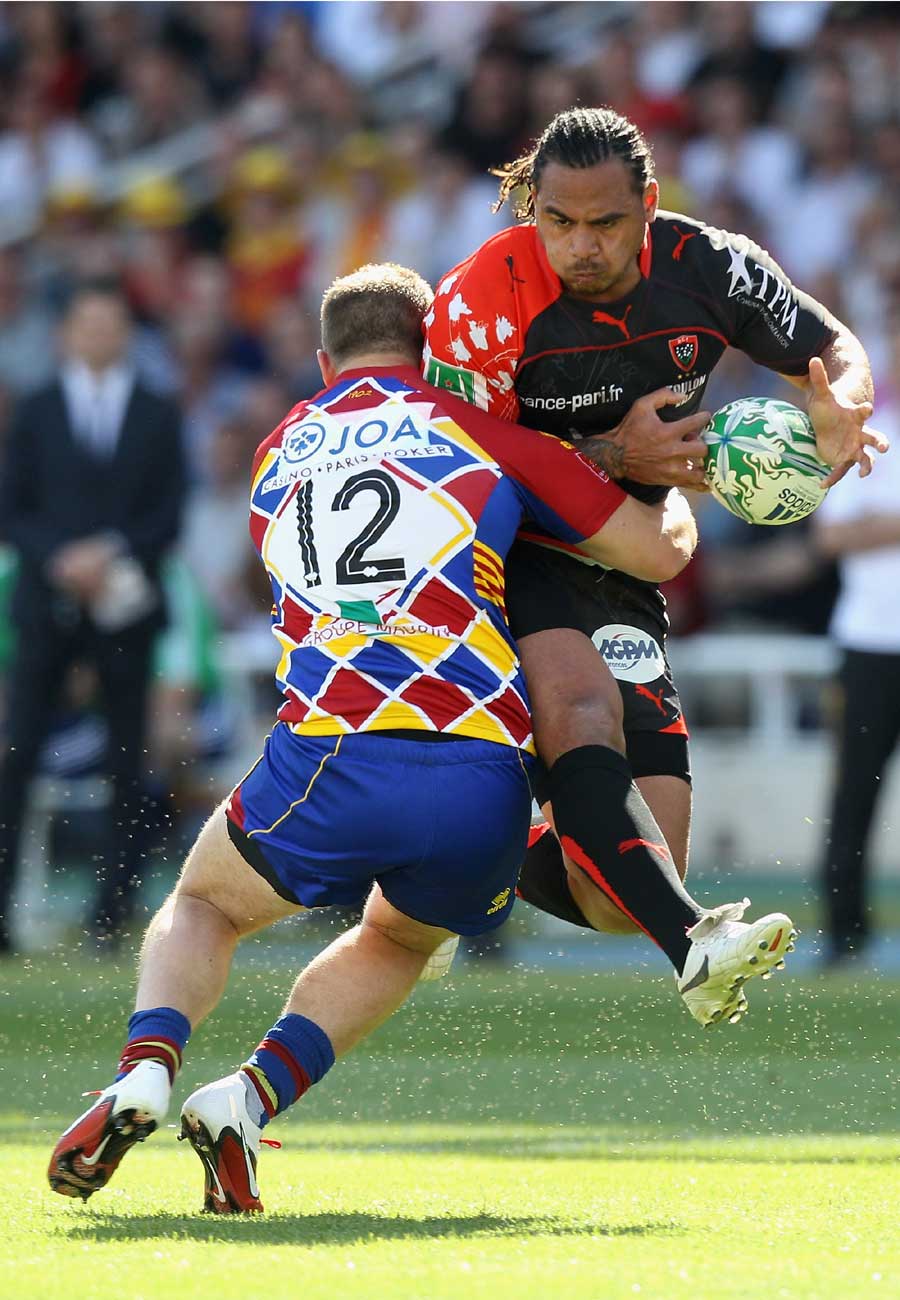 Toulon's Christian Loamanu is tackled by Perpignan's Jean Philippe Grandclaude