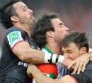 Biarritz's Marcelo Bosch is sandwiched by Toulouse's Clement Poitrenaud and Vincent Clerc
