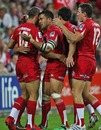 The Reds' Quade Cooper is congratulated on a try