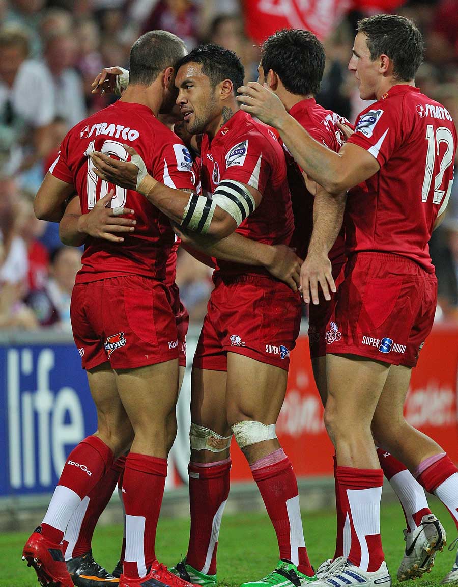 The Reds' Quade Cooper is congratulated on a try