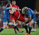 The Reds' Luke Morahan is shackled by the Bulls