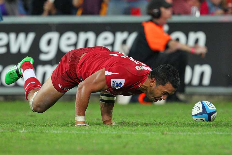 The Reds' Digby Ioane celebrates his try against the Bulls
