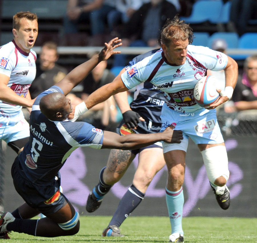 Bourgoin's Julien Frier is tackled by Castres' Ibrahim Diarra