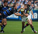 Bath fly-half Butch James grapples with Quins opposite number Nick Evans