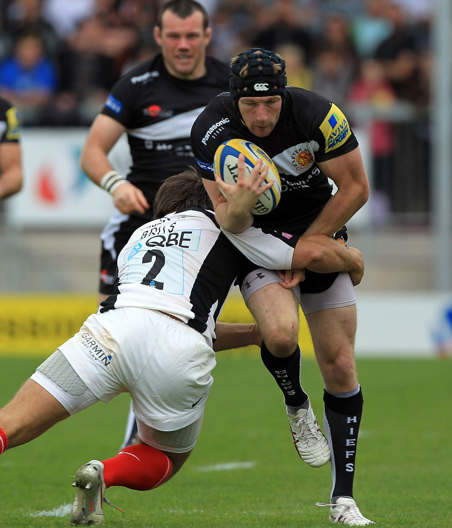 Exeter's Matt Jess charges into Schalk Brits of Saracens
