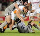 The Cheetahs' Coenie Oosthuizen is felled by the Hurricanes' defence