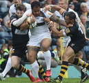 Leeds' Henry Fa'afili holds off tackles from Wasps' Riki Flutey and Elliot Daly