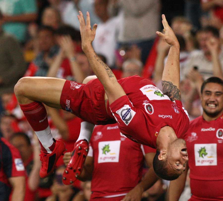 Reds fly-half Quade Cooper celebrates scoring a try