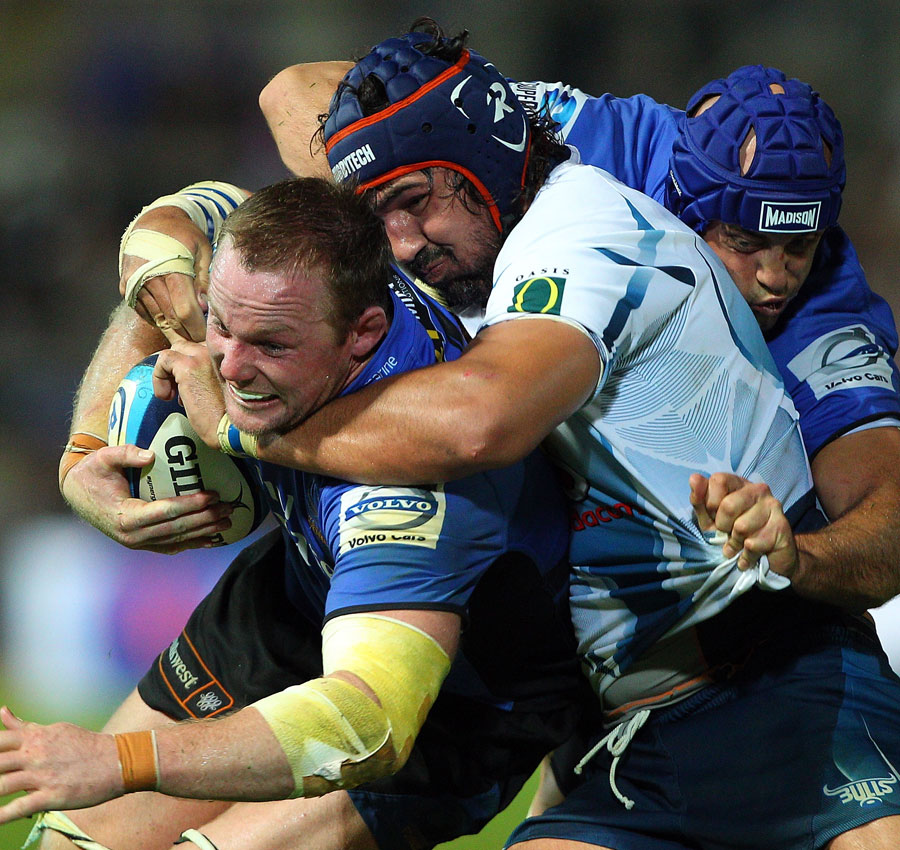 Western Force back-row Richard Brown is wrapped up by the Bulls' Victor Mattfield