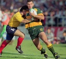 Australia's Joe Roff takes on the Romania defence