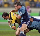 The Hurricanes' Aaron Cruden is shackled by the Blues' defence