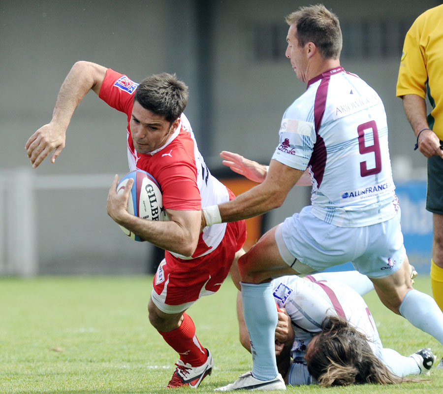 Biarritz's Dimitri Yachvili is caught by a Bourgoin tackler