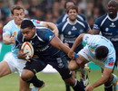 Castres centre Seremaia Baikeinuku is tackled by Perpignan's Gavin Hume