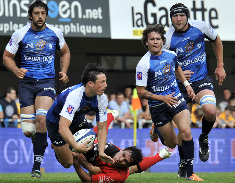 Montpellier fly-half Francios Trinh-Duc is caught by a Toulon tackler