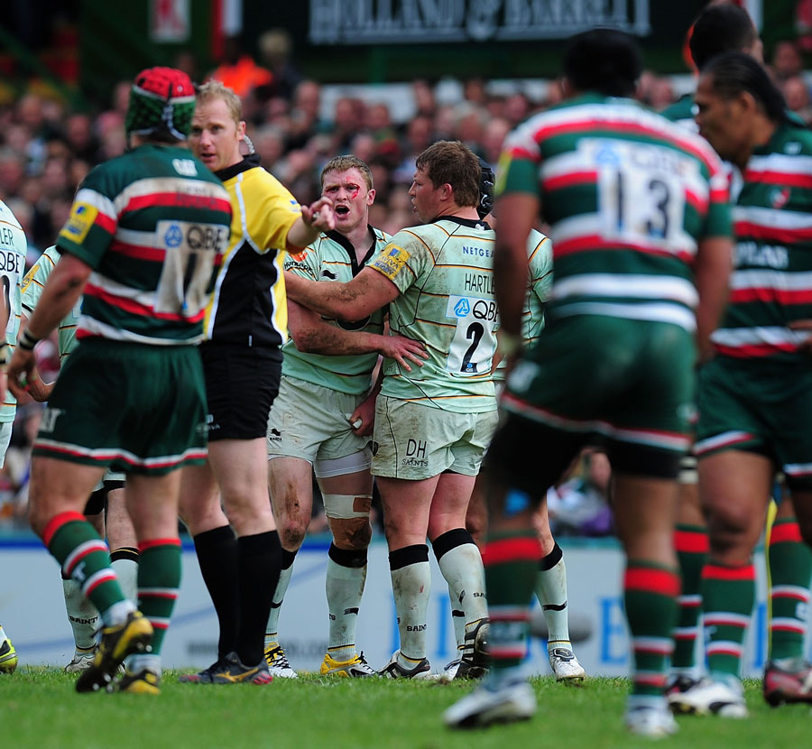 A bloodied Chris Ashton is held back by Dylan Hartley after being punched by Manu Tuilagi