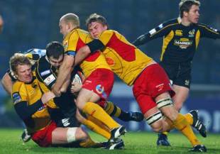 Damien Varley of Wasps is tackled by Jamie Ringer, Richard Fussell and Ashley Smith of Newport Gwent Dragons during the EDF Energy Cup, Group A match between London Wasps and Newport Gwent Dragons at Adams Park in High Wycolme, England on November 2, 2008.