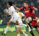 Chiefs fullback Mils Muliaina takes the ball under pressure from the Crusaders' Richie McCaw