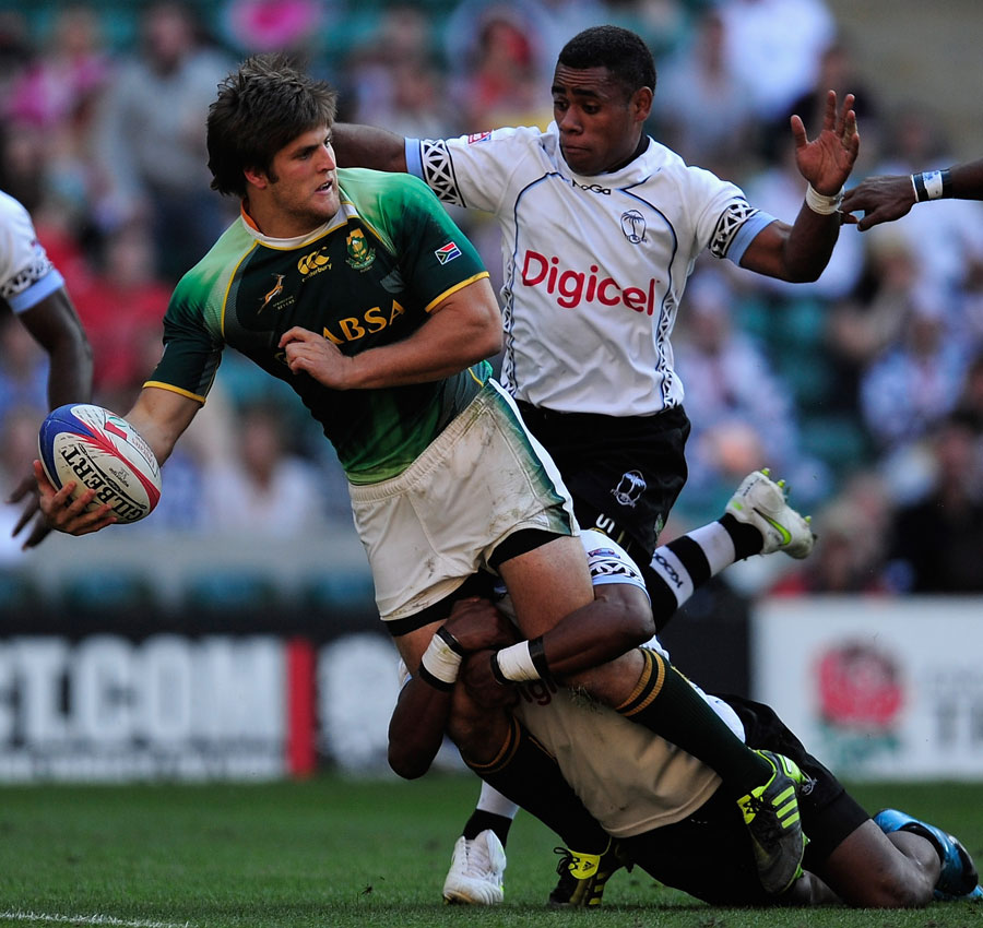 South Africa's Neil Powell is tackled by Fiji's Livai Ikanikoda