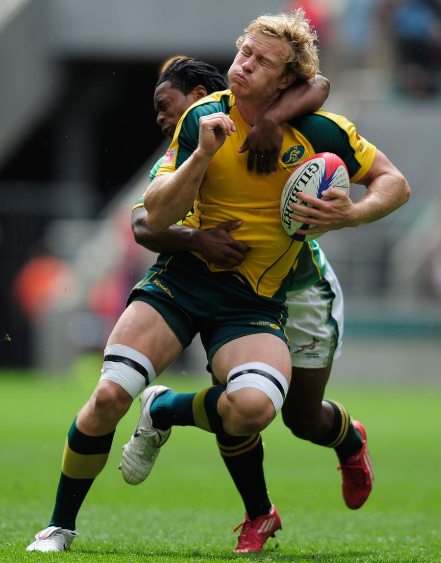Australia's Henry Vanderglasis tackled by South Africa's Cecil Afrika