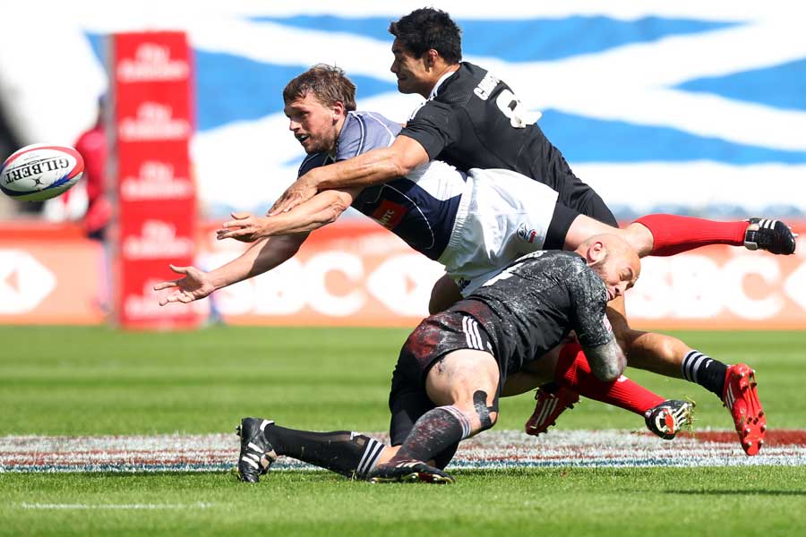Russia's Sergey Sugrobov is tackled by New Zealand's DJ Forbes and Shane Christie 
