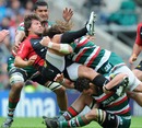 Saracens' Schalk Brits is sent flying by Leicester's Martin Castrogiovanni
