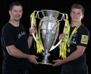 Saracens coach Andy Farrell and fly-half Owen Farrell pose with the Premiership trophy