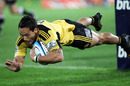 The Hurricanes' Hosea Gear dives under the posts to score against the Lions