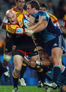 The Chiefs' Brendon Leonard of the Chiefs is brought down by the Blues' Luke Braid