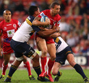 Reds fly-half Quade Cooper is held up by the Brumbies defence 
