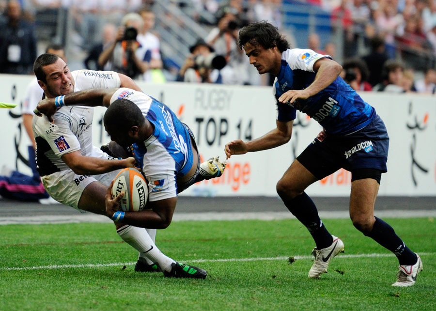 Montpellier No.8 Masi Matadigo is tackled by Jean-Marc Doussain