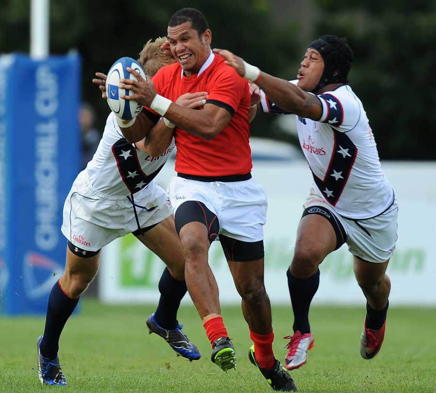  Tonga's Etueni Siua stretches the USA defence
