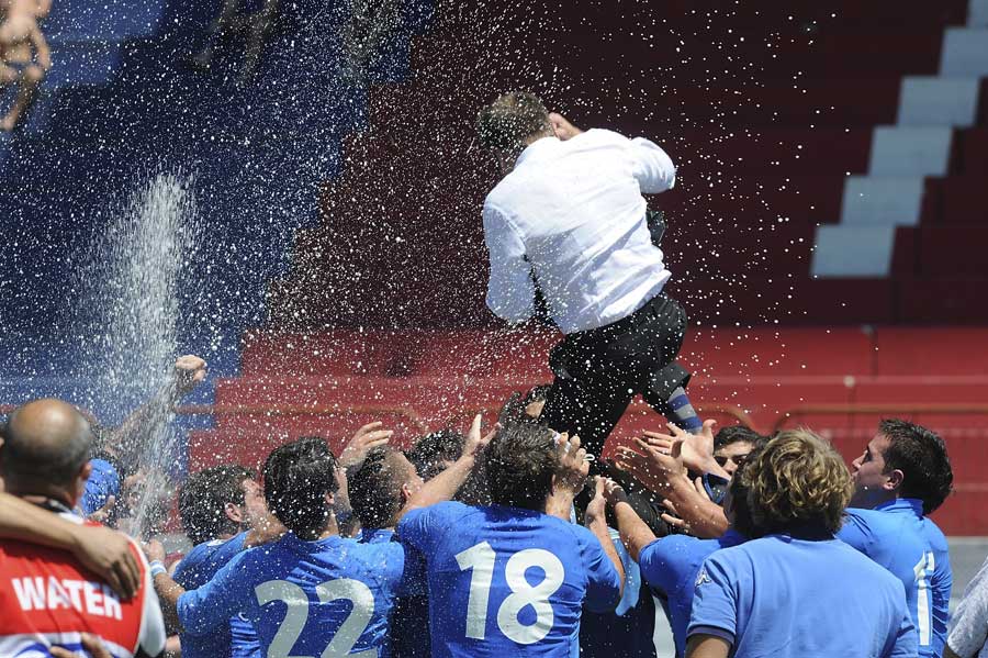 Italy coach Andrea Cavinato is hoisted in the air as Italy celebrate their victory