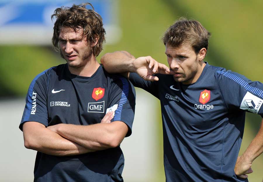 France's Vincent Clerc leans on Maxime Medard during training